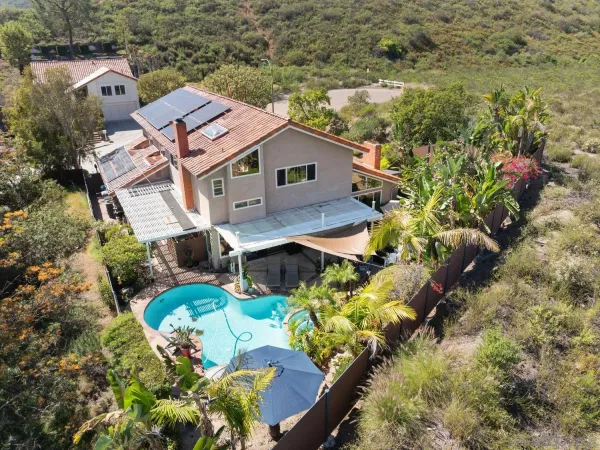 an aerial view of a house with a yard