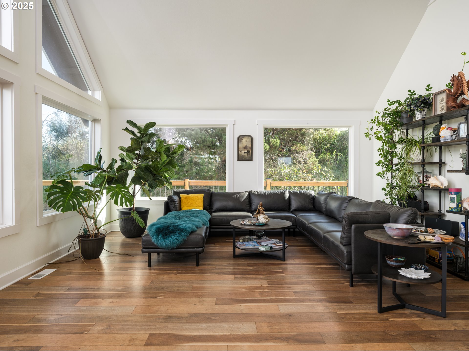 33340 Sunset Beach Road Warrenton, OR 97146 - Photo 16 of 48 a living room with furniture potted plant floor to ceiling windows and a fireplace