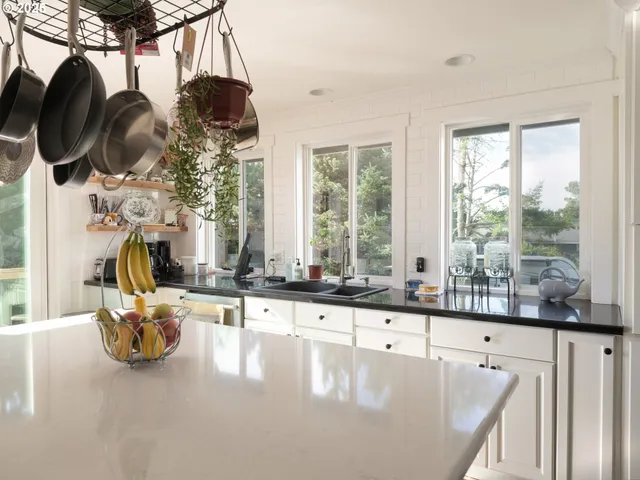 a view of a living room and chandelier fan