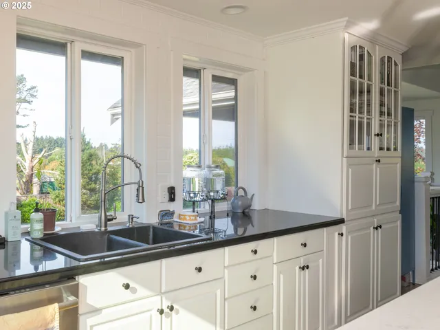 a kitchen with granite countertop a sink and a window