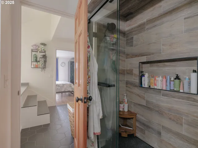 a view of a room that has a bed and a mirror in it