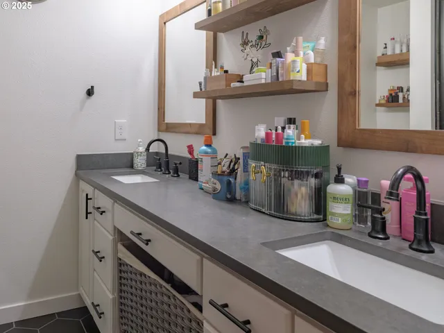 a kitchen with a sink and a stove with wooden floor