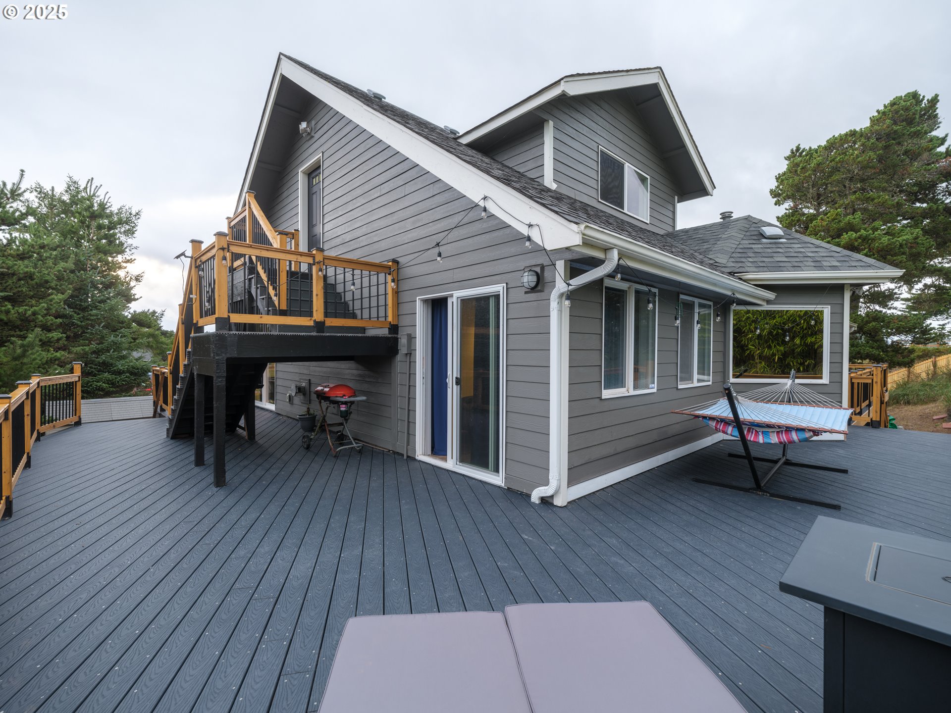 33340 Sunset Beach Road Warrenton, OR 97146 - Photo 41 of 48 a view of house with deck outdoor seating and wooden floor