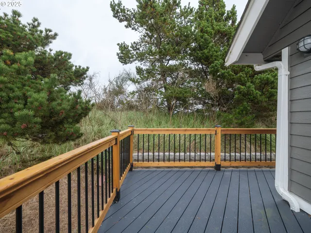 a view of balcony with wooden floor and fence