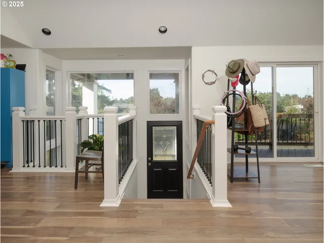 a view of a livingroom with furniture wooden floor and a window