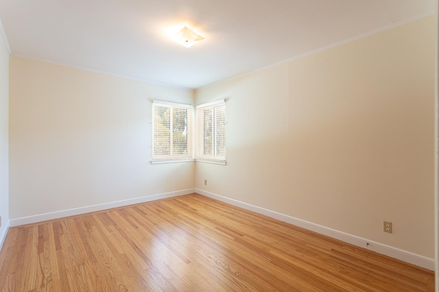 20 Fairview Place Millbrae, CA 94030 - Photo 15 of 21 an empty room with wooden floor and windows