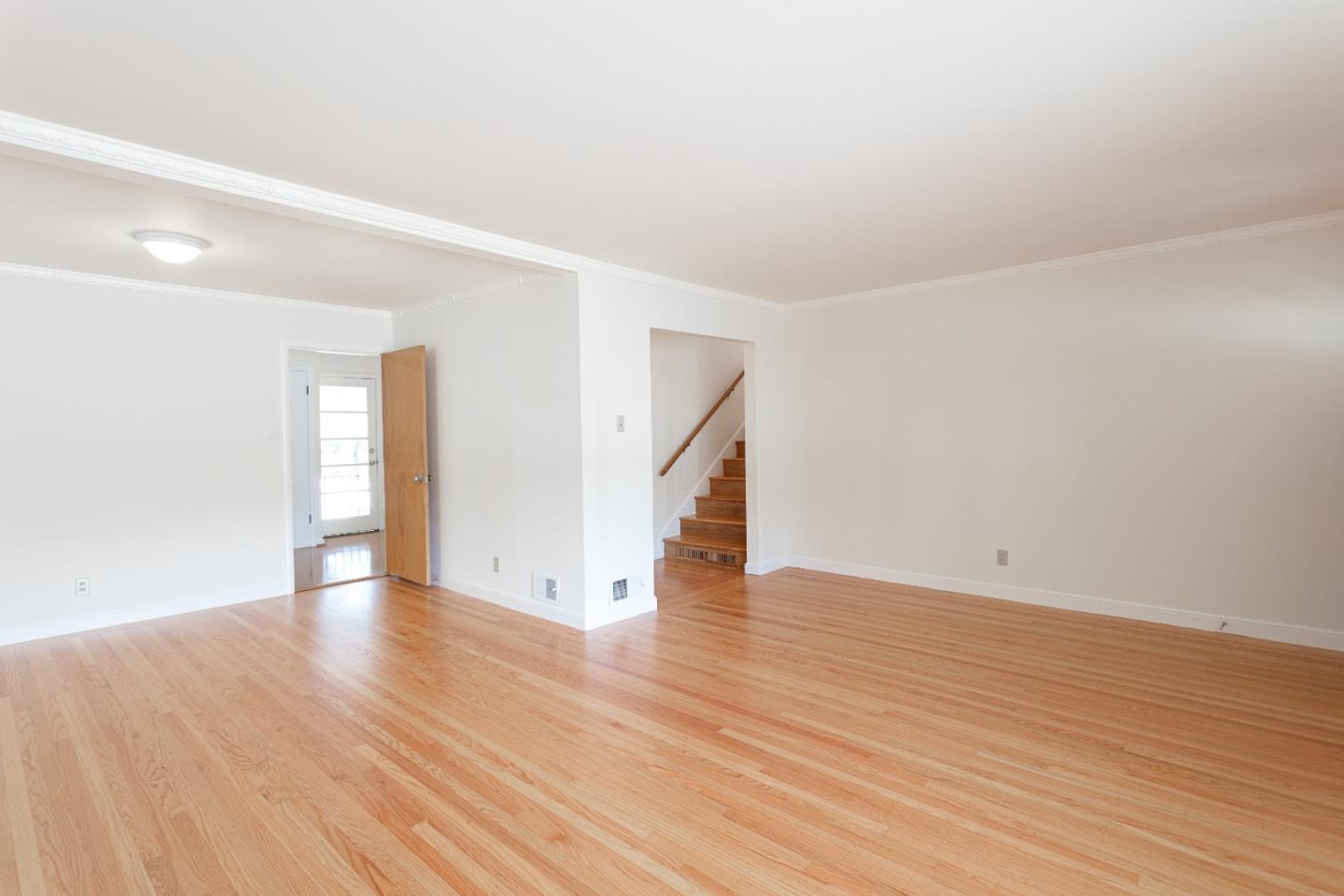 20 Fairview Place Millbrae, CA 94030 - Photo 6 of 21 a view of an empty room with wooden floor and stairs