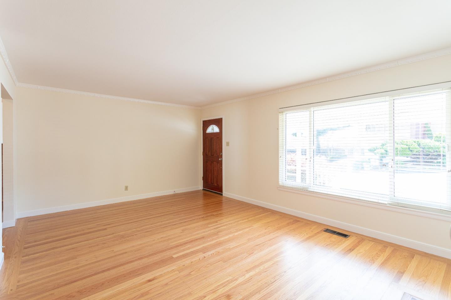 20 Fairview Place Millbrae, CA 94030 - Photo 7 of 21 a view of an empty room with wooden floor and a window