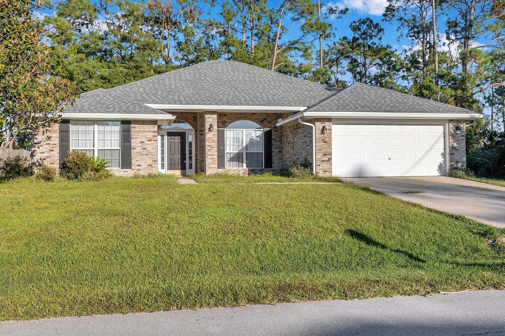 98 Roxboro Drive Palm Coast, FL 32164 - Photo 1 of 28 a front view of a house with yard and green space