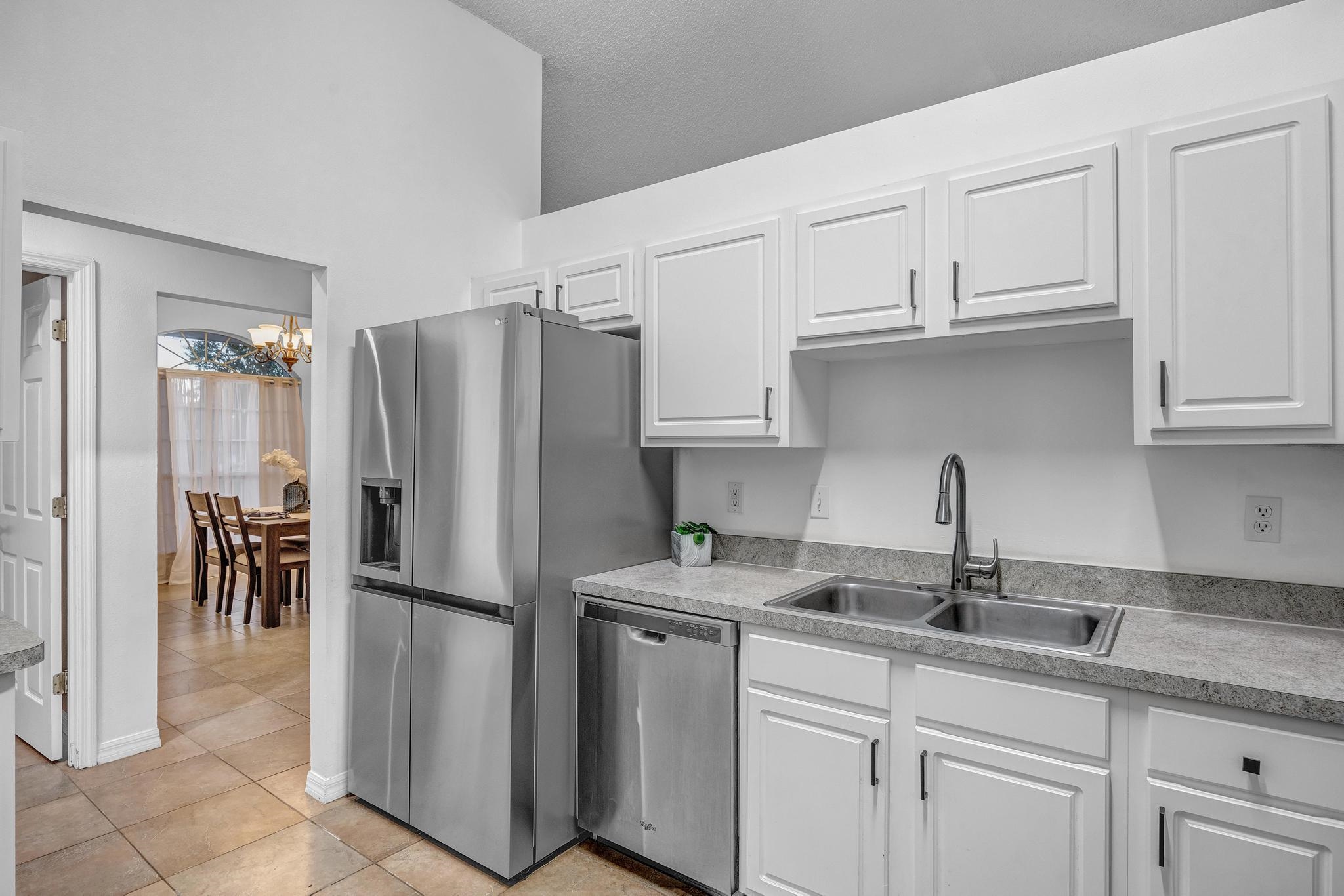 98 Roxboro Drive Palm Coast, FL 32164 - Photo 13 of 28 a kitchen with stainless steel appliances granite countertop a refrigerator and a sink