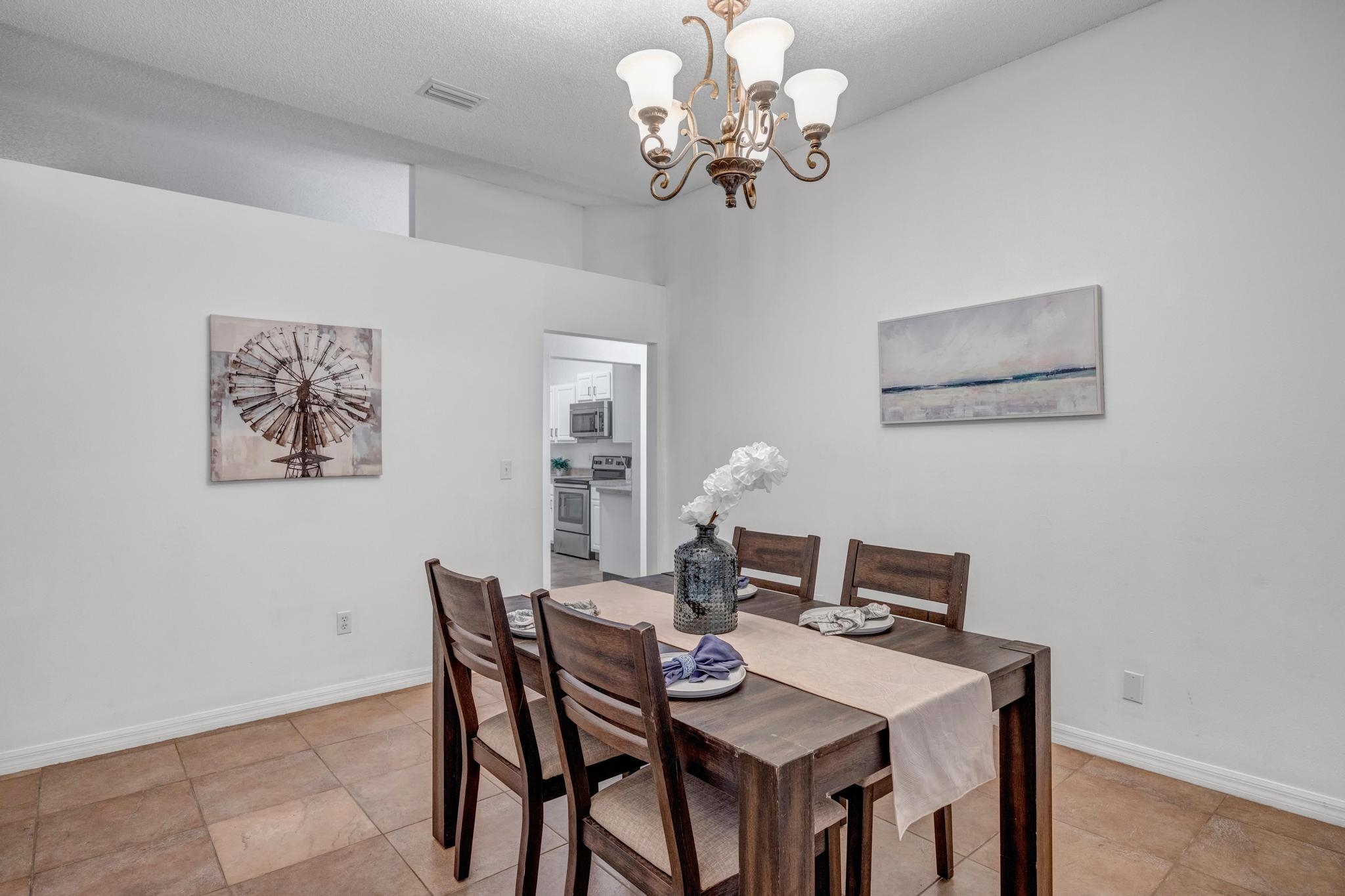 98 Roxboro Drive Palm Coast, FL 32164 - Photo 14 of 28 a view of a dining room with furniture and chandelier