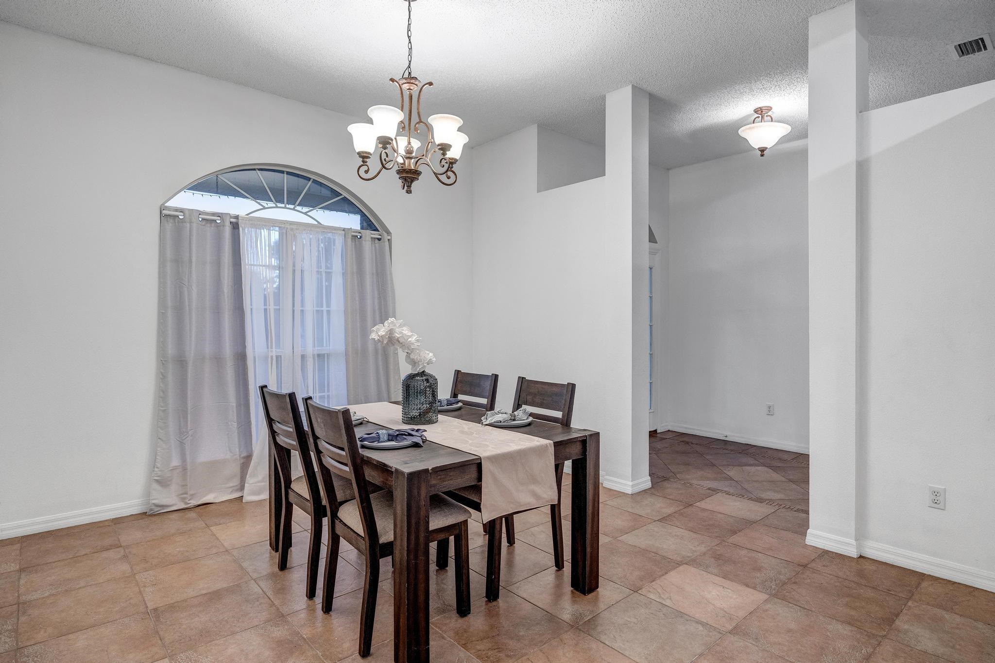 98 Roxboro Drive Palm Coast, FL 32164 - Photo 15 of 28 a view of a dining room with furniture and chandelier