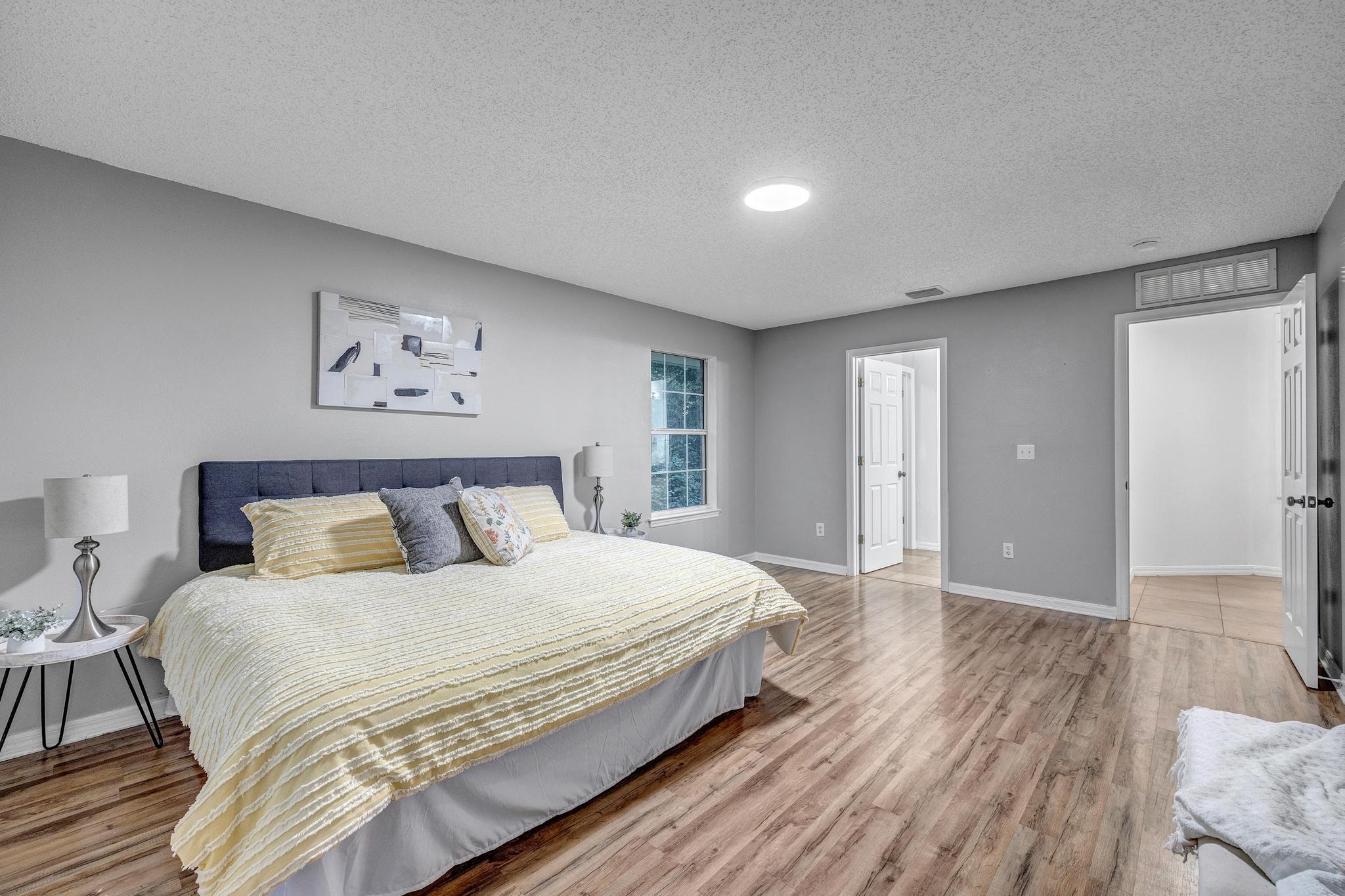 98 Roxboro Drive Palm Coast, FL 32164 - Photo 17 of 28 a bedroom with a bed and a painting on the wall