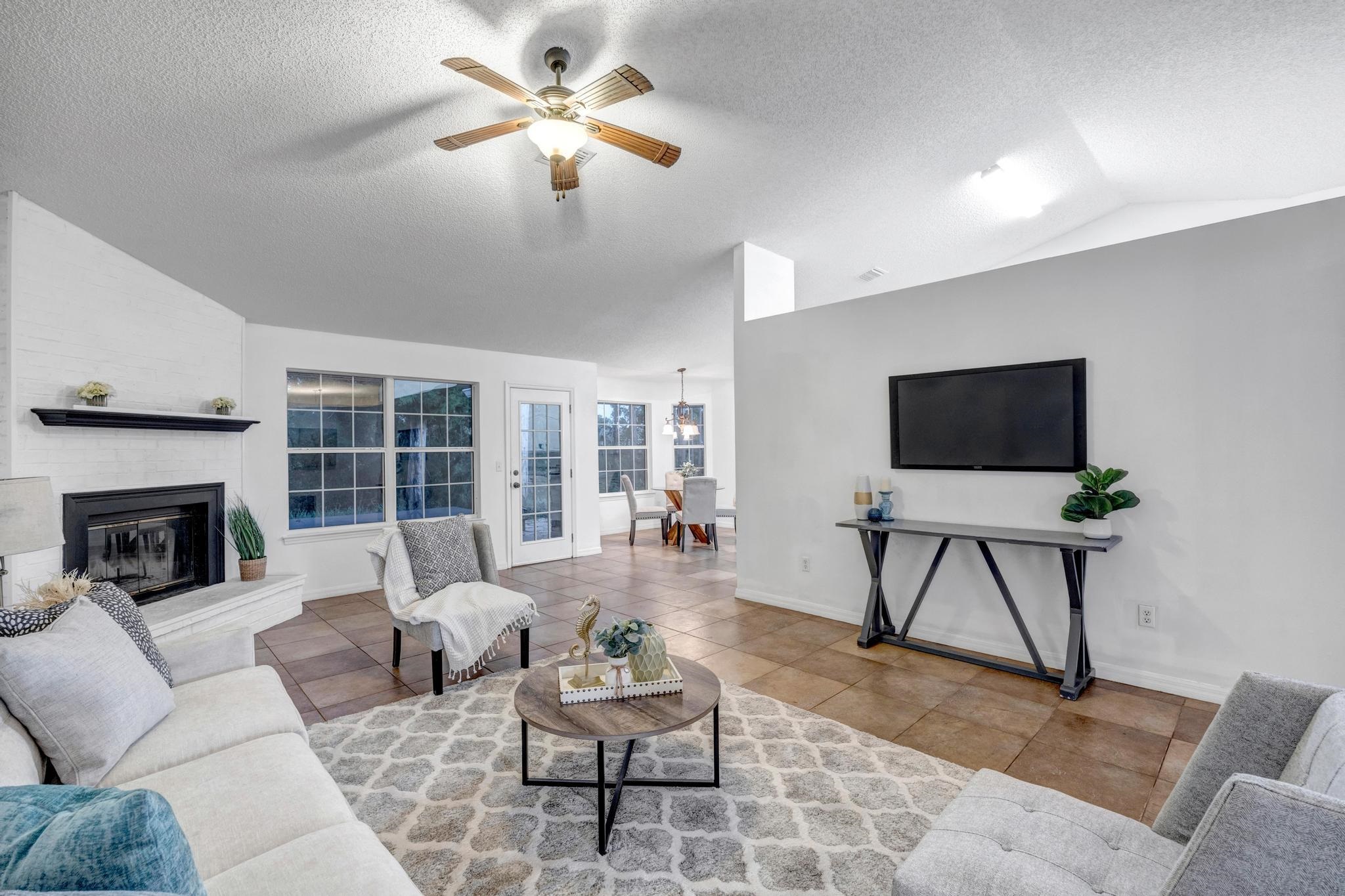 98 Roxboro Drive Palm Coast, FL 32164 - Photo 2 of 28 a living room with furniture and a flat screen tv