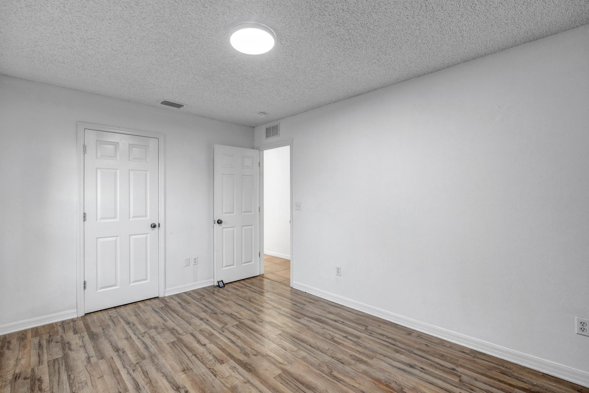 98 Roxboro Drive Palm Coast, FL 32164 - Photo 22 of 28 a view of an empty room and wooden floor