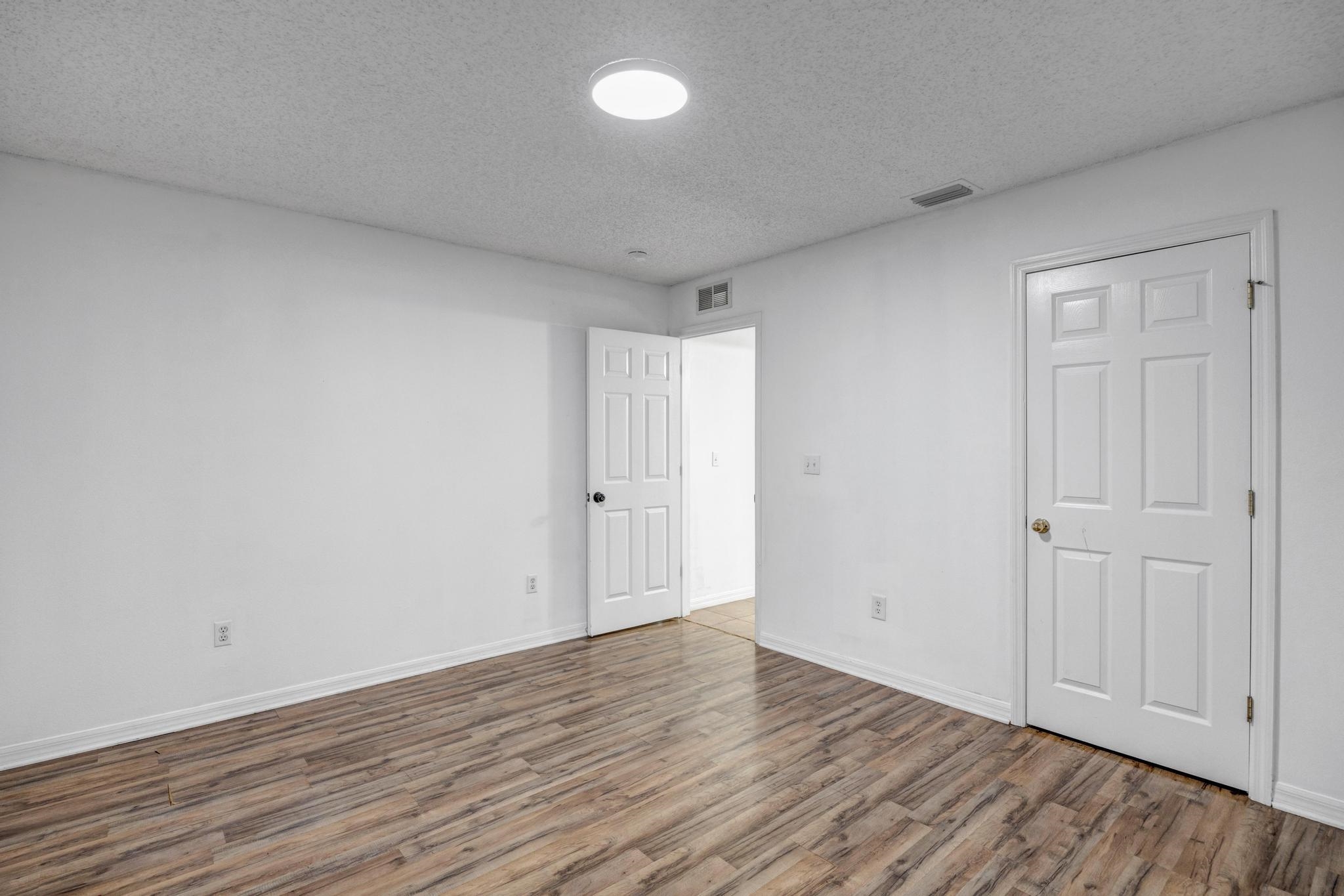 98 Roxboro Drive Palm Coast, FL 32164 - Photo 24 of 28 a view of an empty room and wooden floor