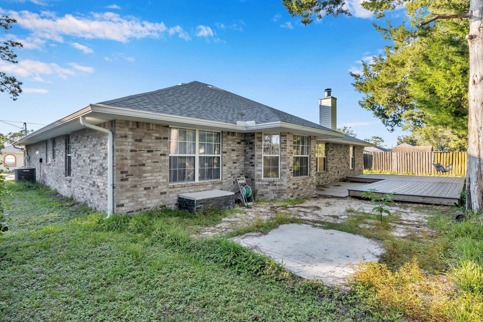 98 Roxboro Drive Palm Coast, FL 32164 - Photo 28 of 28 a view of a house with a yard and sitting area