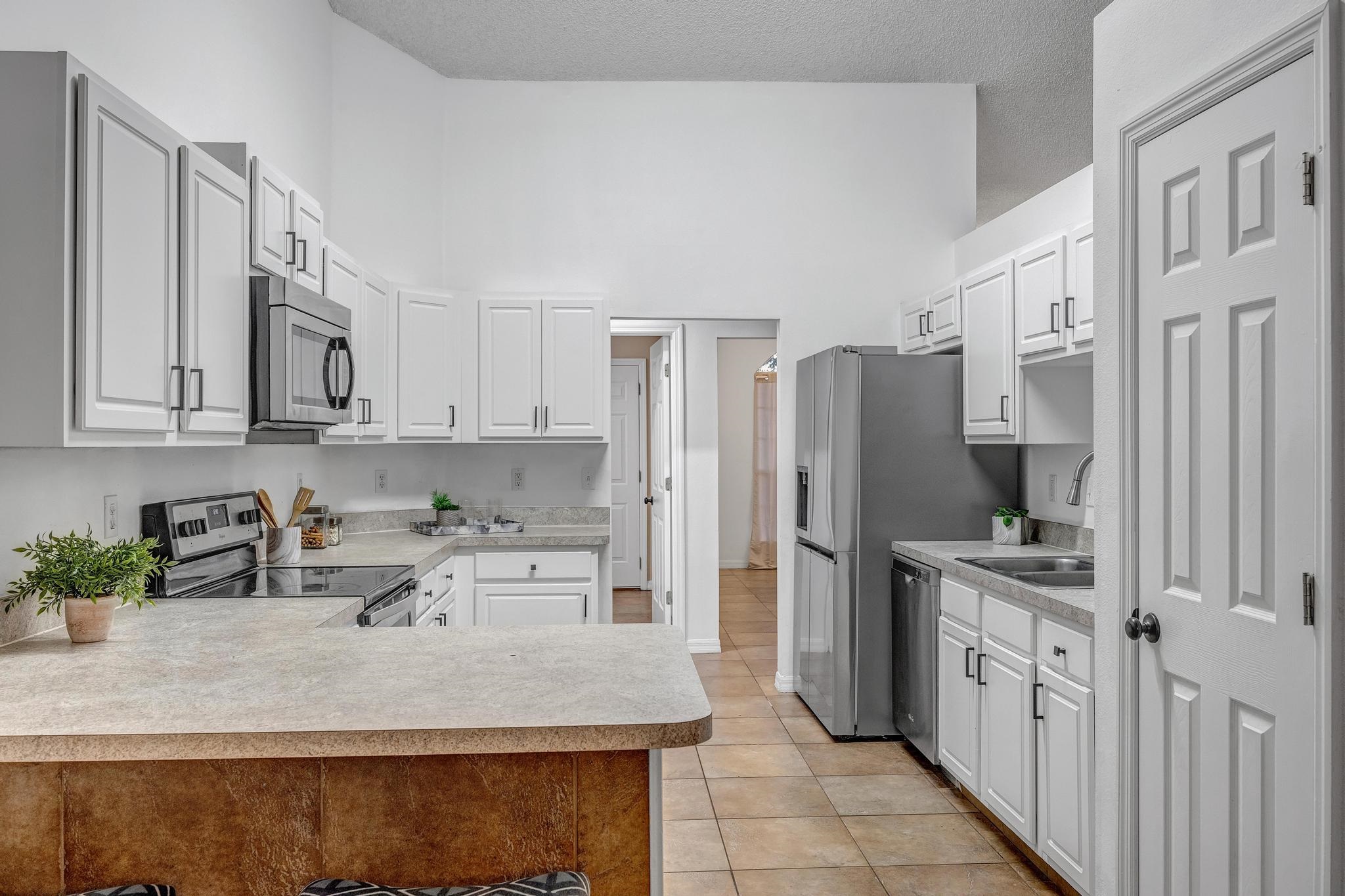 98 Roxboro Drive Palm Coast, FL 32164 - Photo 3 of 28 a kitchen with stainless steel appliances granite countertop a sink stove and refrigerator