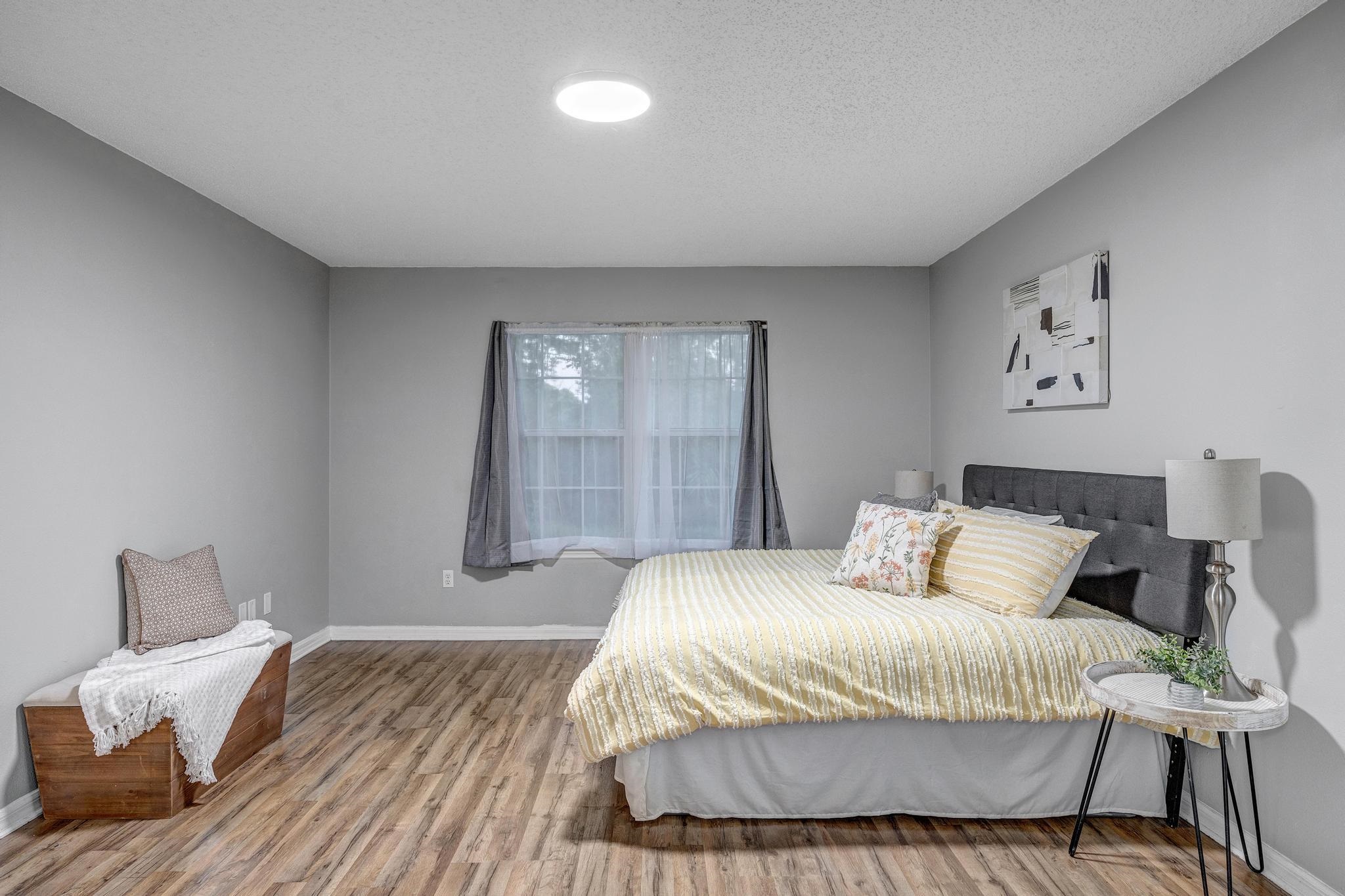 98 Roxboro Drive Palm Coast, FL 32164 - Photo 4 of 28 a bedroom with a bed and painting on the wall