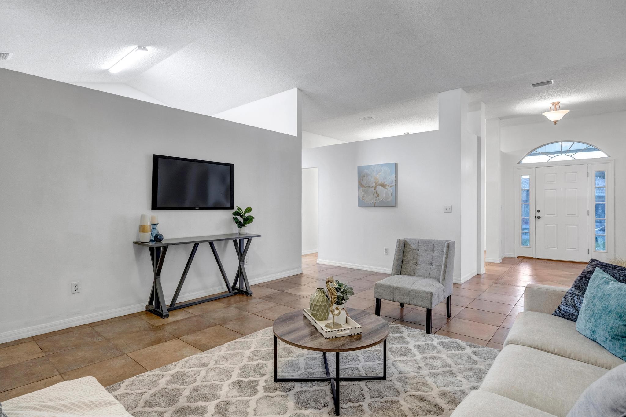 98 Roxboro Drive Palm Coast, FL 32164 - Photo 6 of 28 a living room with furniture and a flat screen tv