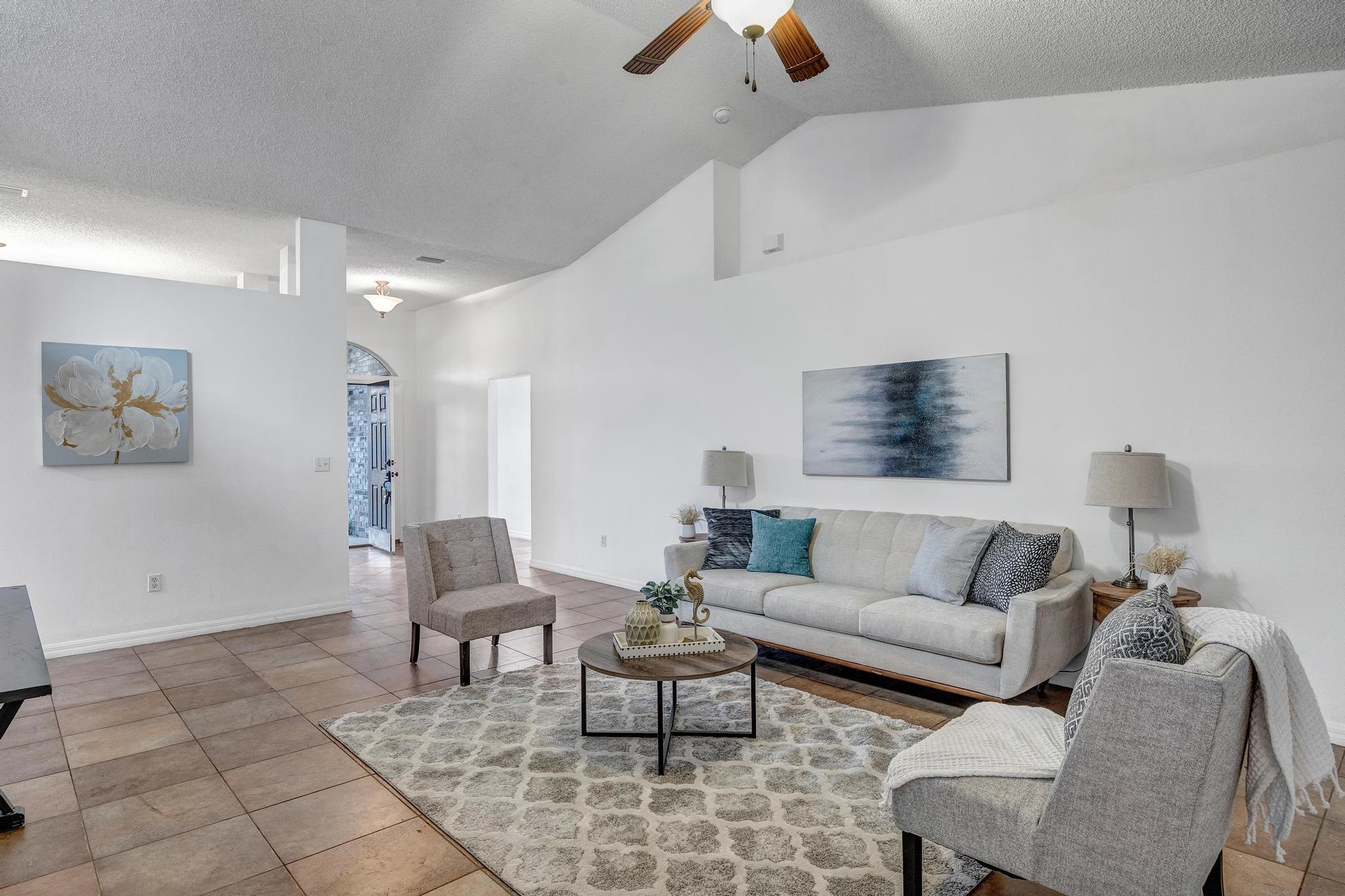 98 Roxboro Drive Palm Coast, FL 32164 - Photo 7 of 28 a living room with furniture and a rug