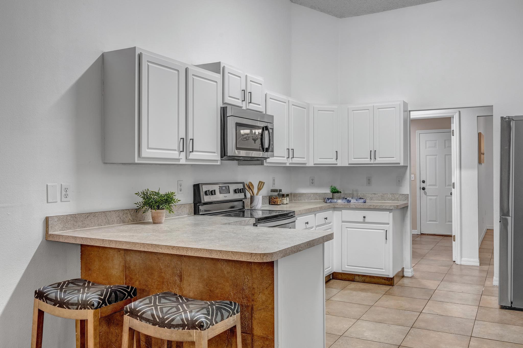 98 Roxboro Drive Palm Coast, FL 32164 - Photo 9 of 28 a kitchen with a stove a sink and cabinets