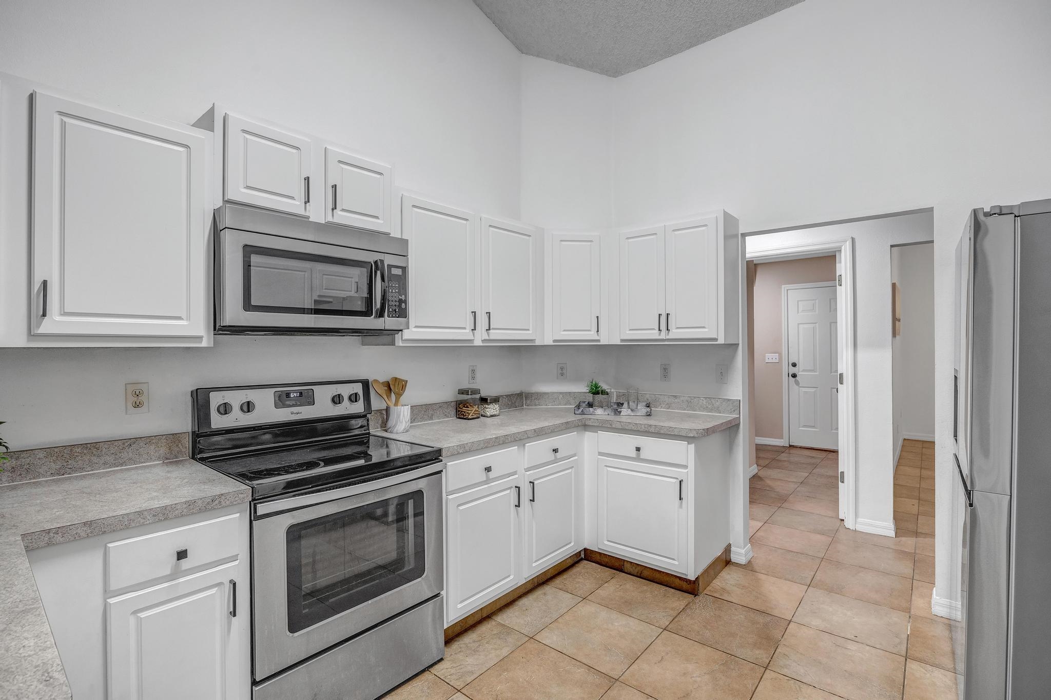 98 Roxboro Drive Palm Coast, FL 32164 - Photo 10 of 28 a kitchen with stainless steel appliances granite countertop white cabinets and a stove