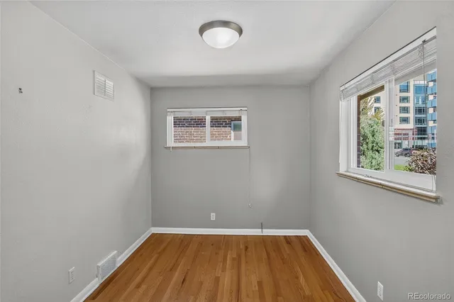 a view of a room with wooden floor and windows