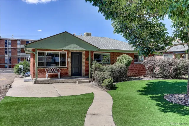 a front view of a house with a yard and porch