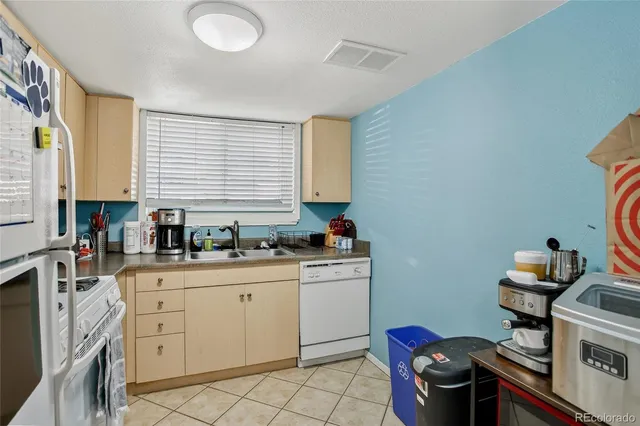 a kitchen with sink cabinets and appliances