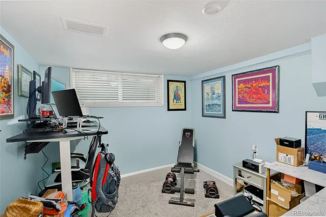 a view of a workspace with furniture and clutter