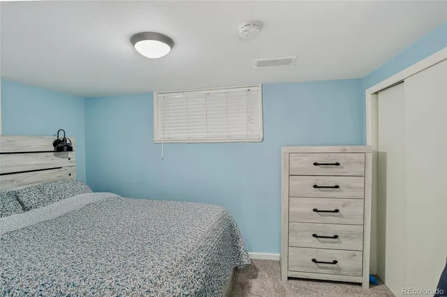 a bedroom with a bed and a dresser