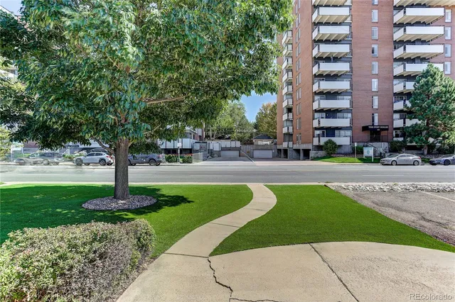 a tall building with trees in front of it