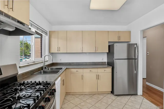a kitchen with a stove a refrigerator and a sink