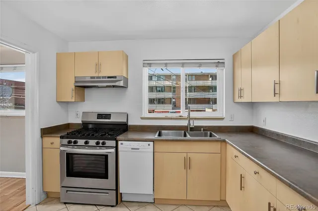 a kitchen with stainless steel appliances granite countertop a sink stove oven a sink and dishwasher with cabinets