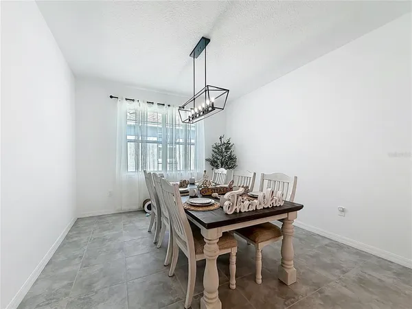 a dining room with furniture and window