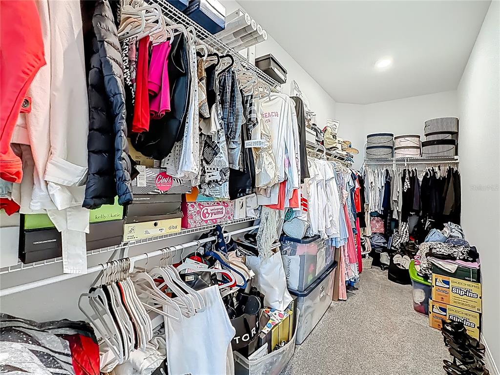 7429 Southwest 61st Street Ocala, FL 34474 - Photo 15 of 40 a view of walk in closet with clothes