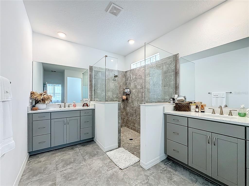 7429 Southwest 61st Street Ocala, FL 34474 - Photo 16 of 40 a bathroom with a double vanity sink toilet and mirror
