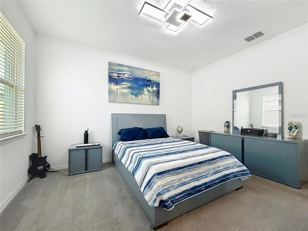 7429 Southwest 61st Street Ocala, FL 34474 - Photo 20 of 40 a bedroom with a bed and a large mirror