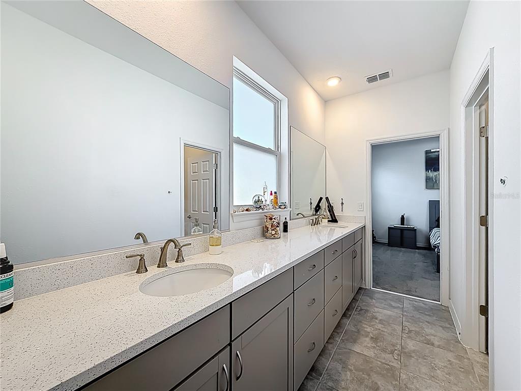 7429 Southwest 61st Street Ocala, FL 34474 - Photo 21 of 40 a bathroom with a double vanity sink and mirror