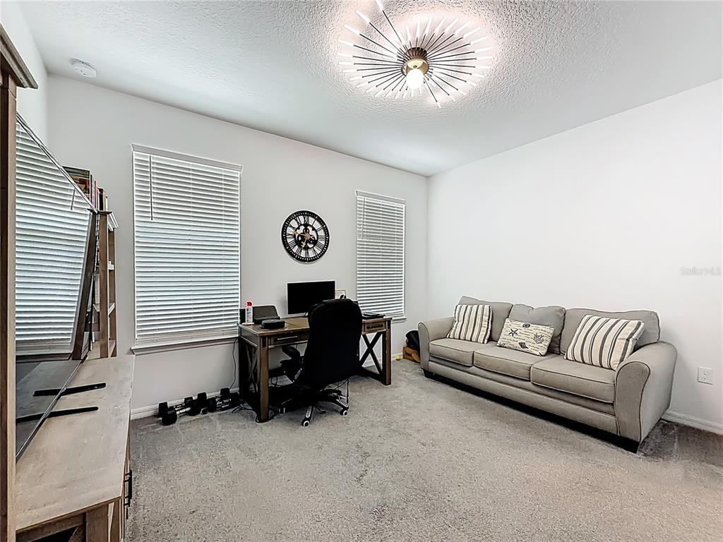 7429 Southwest 61st Street Ocala, FL 34474 - Photo 22 of 40 a living room with furniture and a large window