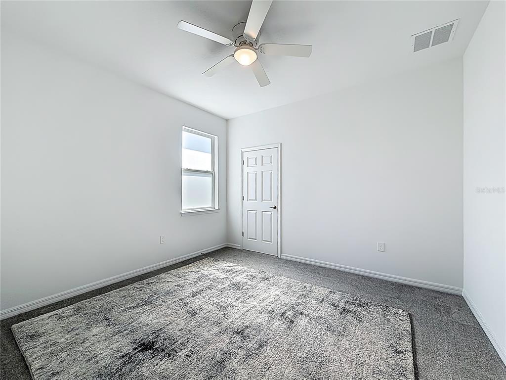 7429 Southwest 61st Street Ocala, FL 34474 - Photo 24 of 40 an empty room with windows and fan