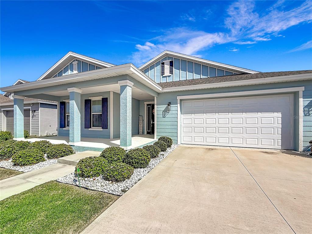 7429 Southwest 61st Street Ocala, FL 34474 - Photo 32 of 40 a front view of a house with a yard and garage