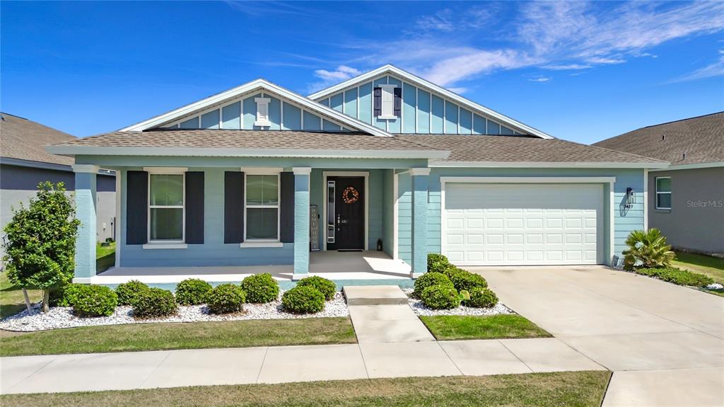 7429 Southwest 61st Street Ocala, FL 34474 - Photo 33 of 40 a front view of a house with a yard and potted plants