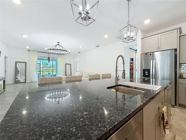a view of a room with chandelier fan and wooden floor