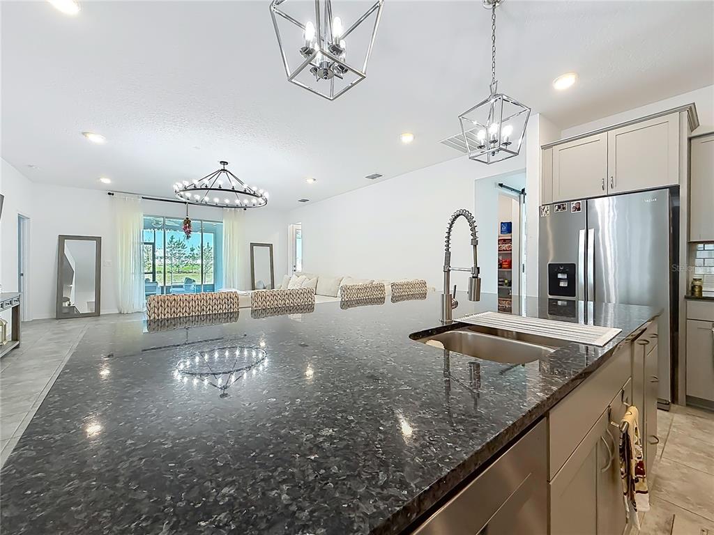 7429 Southwest 61st Street Ocala, FL 34474 - Photo 6 of 40 a view of a room with chandelier fan and wooden floor