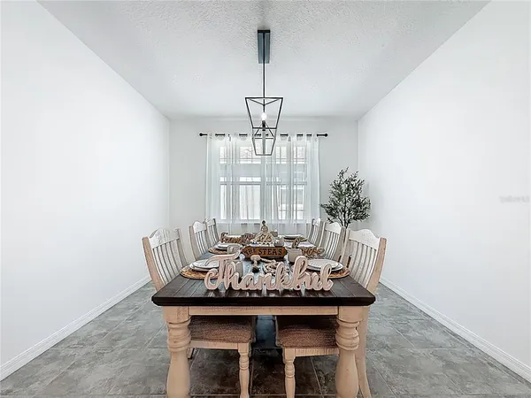 a view of a dining room with furniture and window