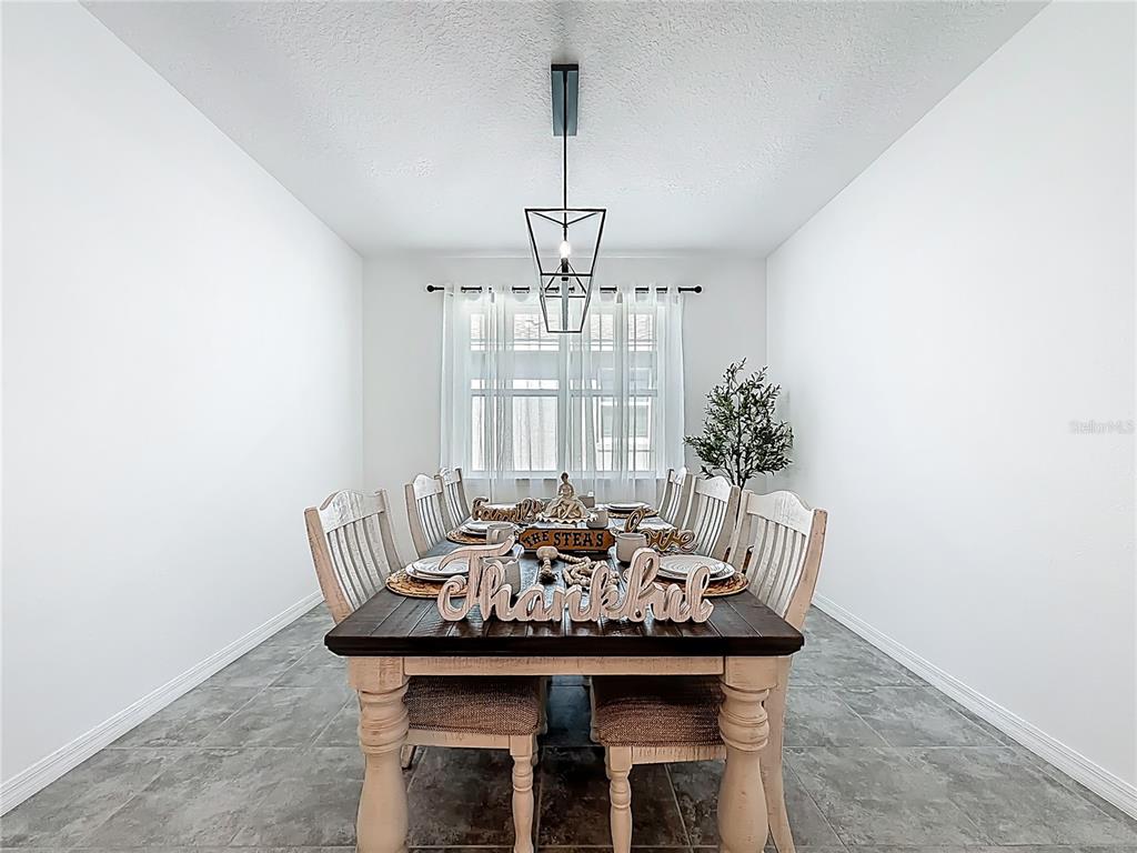 7429 Southwest 61st Street Ocala, FL 34474 - Photo 10 of 40 a view of a dining room with furniture and window