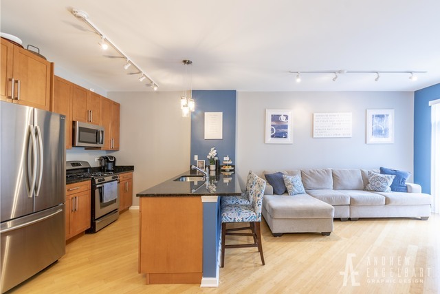 757 West 14th Street, Unit 1B Chicago, IL 60607 - Photo 4 of 13 a living room with stainless steel appliances furniture and a kitchen view