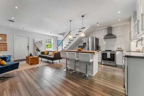 a living room with furniture and a wooden floor